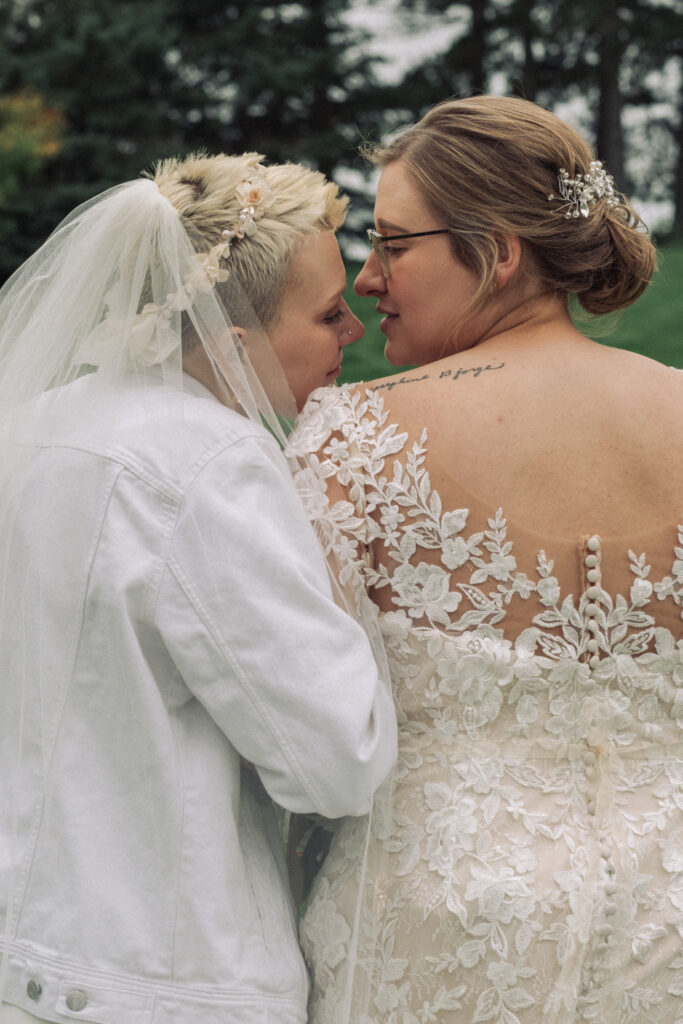 lesbian couple embrace after small wedding ceremony