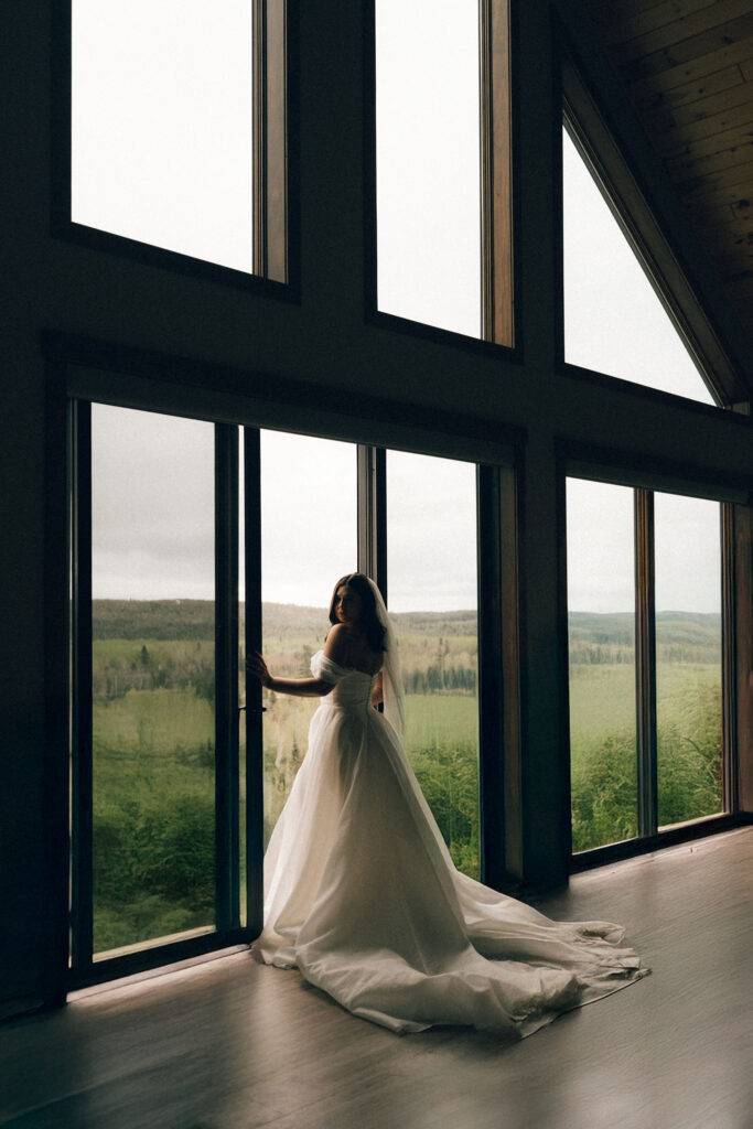 Minnesota bride standing next to a-frame windows