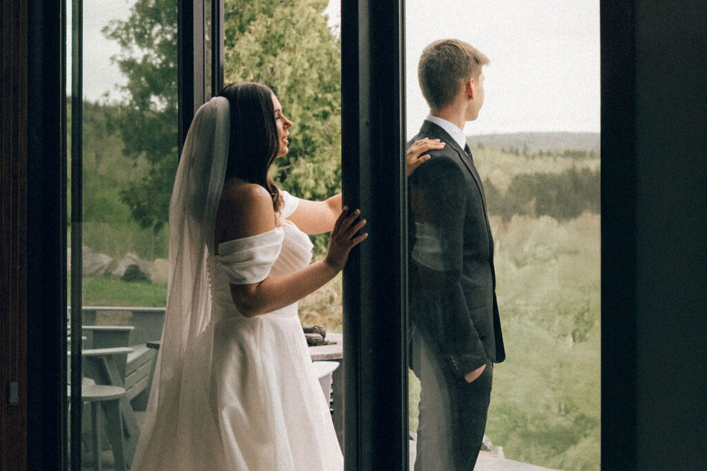 bride taps groom on shoulder during first look