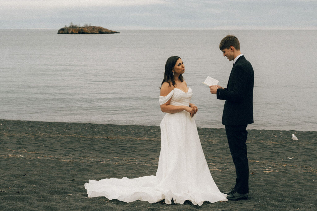bride and groom exchange vows on gorgeous mn black beach outdoor location