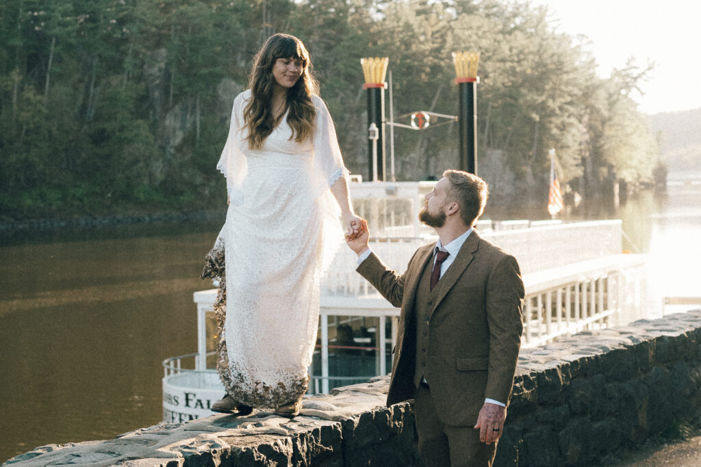 bride and groom hold hands and explore mn outdoor elopement location interstate state park