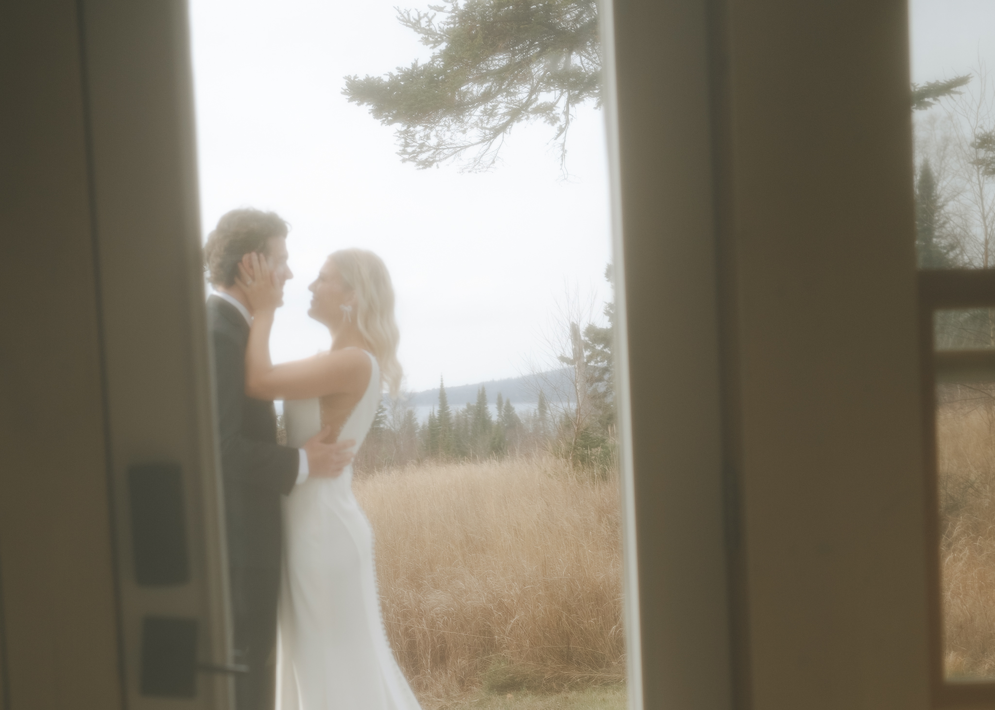 Minnesota elopement couple enjoy an embrace outside of their cabin